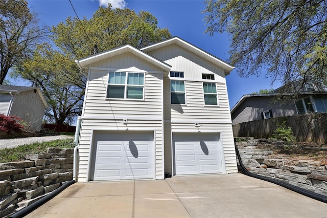 exterior space featuring driveway and fence