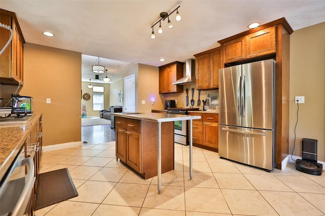 kitchen with light tile patterned flooring, brown cabinetry, a center island, wall chimney exhaust hood, and appliances with stainless steel finishes