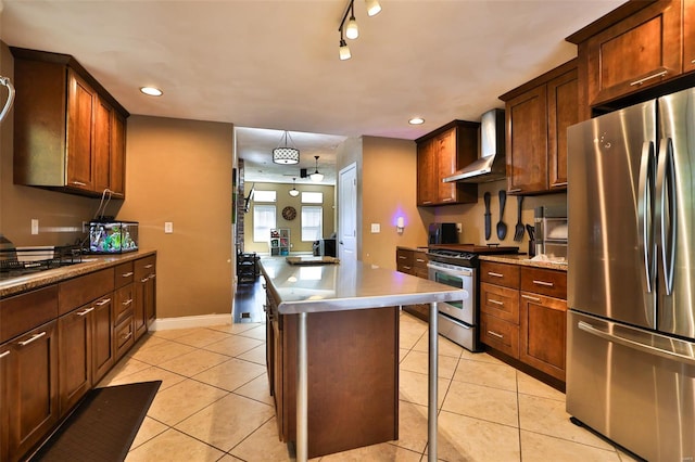 kitchen featuring a breakfast bar, recessed lighting, wall chimney exhaust hood, and appliances with stainless steel finishes