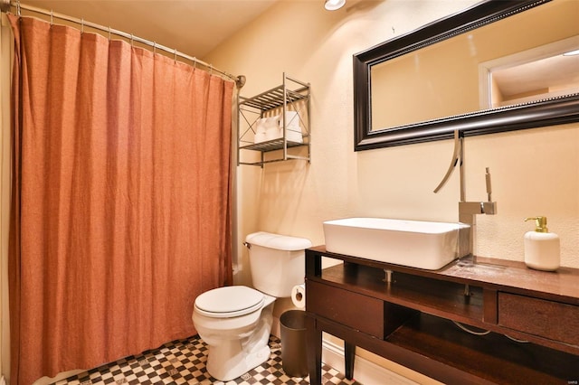 bathroom featuring tile patterned floors, a shower with shower curtain, toilet, and vanity