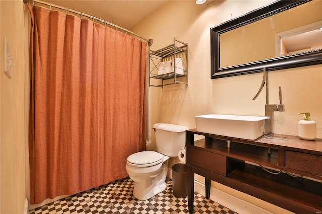 bathroom featuring tile patterned floors, toilet, a shower with curtain, and vanity