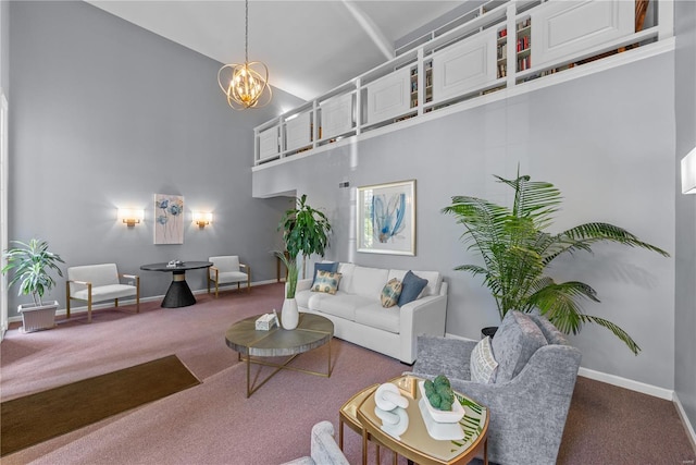 carpeted living area with a chandelier, a towering ceiling, and baseboards