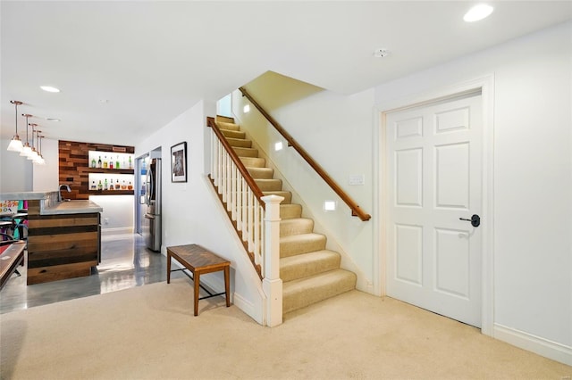 staircase featuring baseboards and recessed lighting