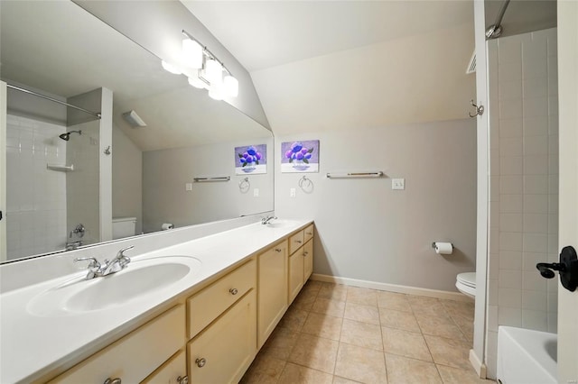bathroom featuring lofted ceiling, a sink, and toilet
