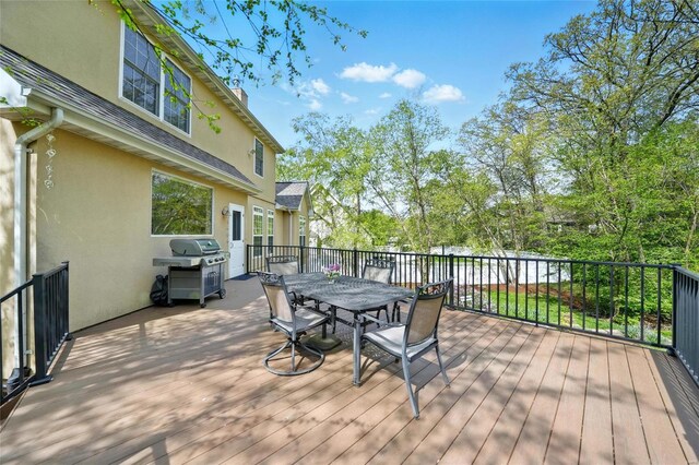 wooden terrace featuring grilling area and outdoor dining space