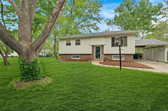 raised ranch with an attached carport, driveway, and a front lawn