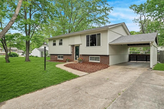 bi-level home with fence, driveway, a front yard, and a carport