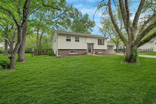 view of front of house with a front lawn and fence