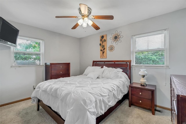 bedroom with baseboards, light carpet, and ceiling fan