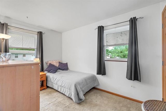 carpeted bedroom featuring baseboards
