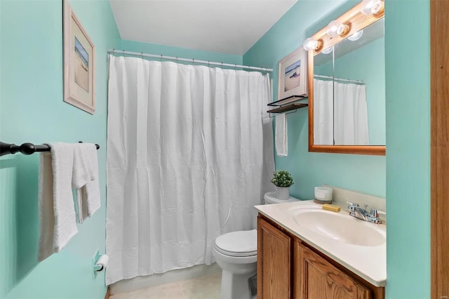 bathroom featuring toilet, a shower with shower curtain, and vanity
