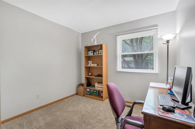 carpeted home office featuring baseboards