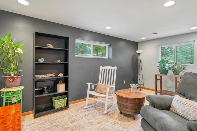 living area with recessed lighting, baseboards, and wood finished floors