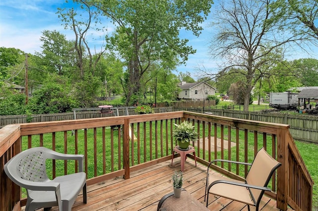 deck with a fenced backyard and a yard