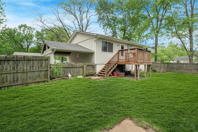 rear view of house with a fenced backyard, a lawn, a wooden deck, and stairs