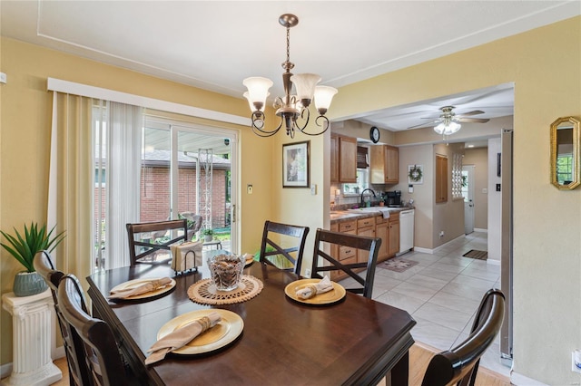 dining space with baseboards, ceiling fan with notable chandelier, and light tile patterned flooring