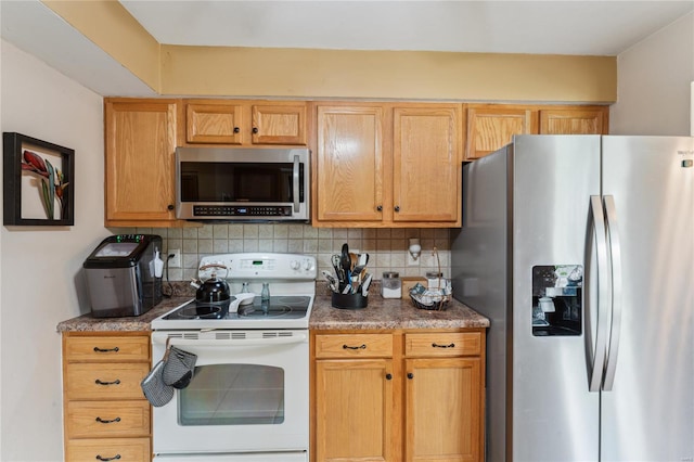 kitchen with appliances with stainless steel finishes and decorative backsplash