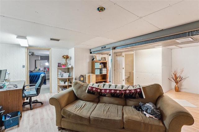 living room featuring visible vents and wood finished floors