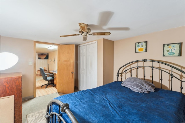 carpeted bedroom featuring a closet and ceiling fan