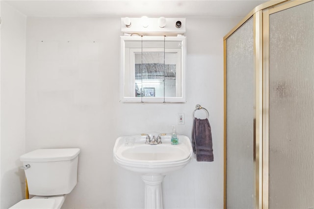 full bath featuring toilet and a stall shower