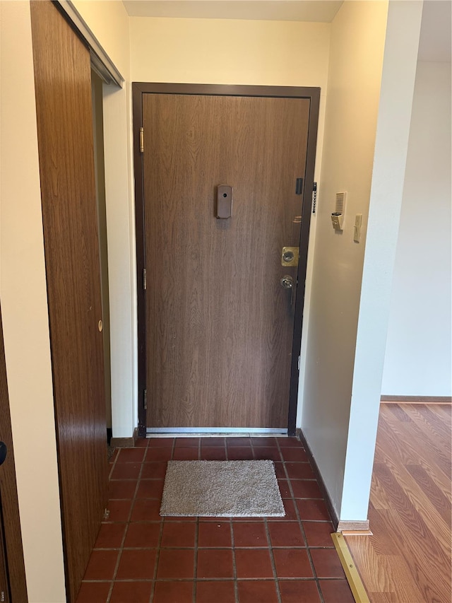 entryway with tile patterned flooring and baseboards