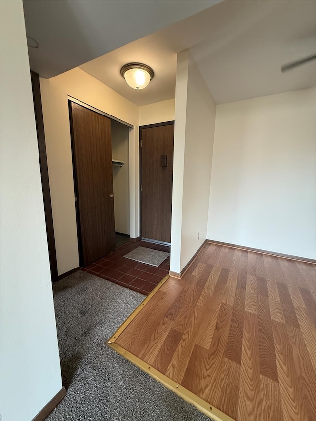 hall featuring baseboards