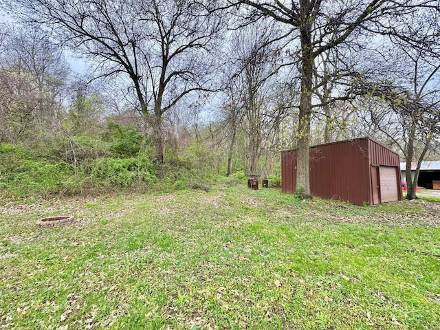 view of yard with an outbuilding, a pole building, and a garage