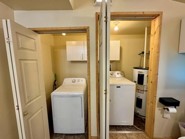 laundry area with cabinet space, electric water heater, light tile patterned floors, and washer / clothes dryer