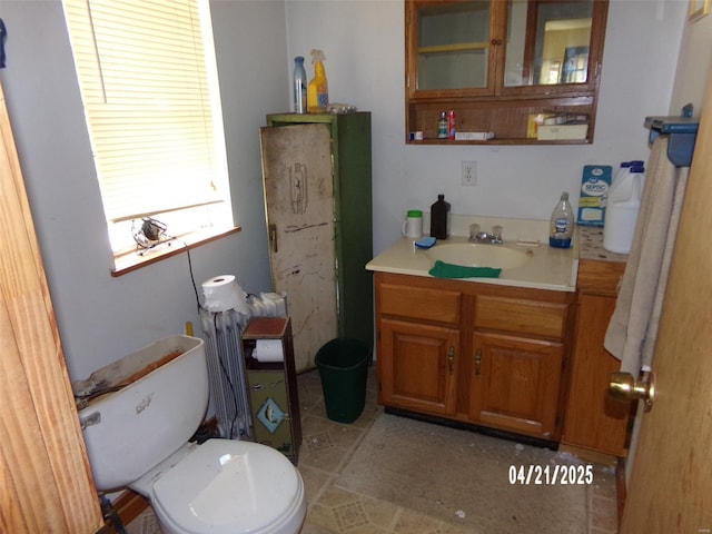 bathroom featuring toilet and vanity