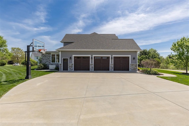 view of side of property with a garage, a lawn, stone siding, and driveway