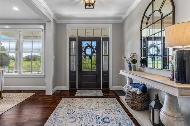 entrance foyer with wood finished floors, baseboards, and ornamental molding