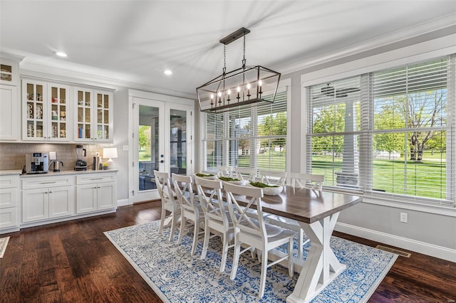 dining room featuring visible vents, french doors, crown molding, baseboards, and dark wood-style flooring