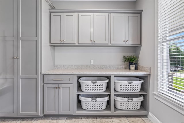 bar featuring baseboards and light tile patterned floors