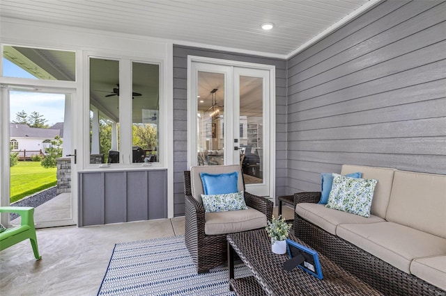sunroom / solarium featuring a ceiling fan, french doors, and an outdoor living space