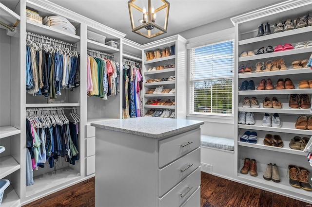spacious closet featuring visible vents, a chandelier, and dark wood finished floors