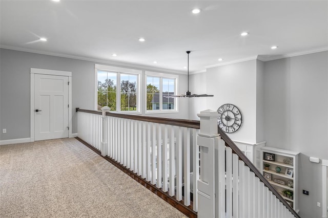 hall with recessed lighting, ornamental molding, and an upstairs landing