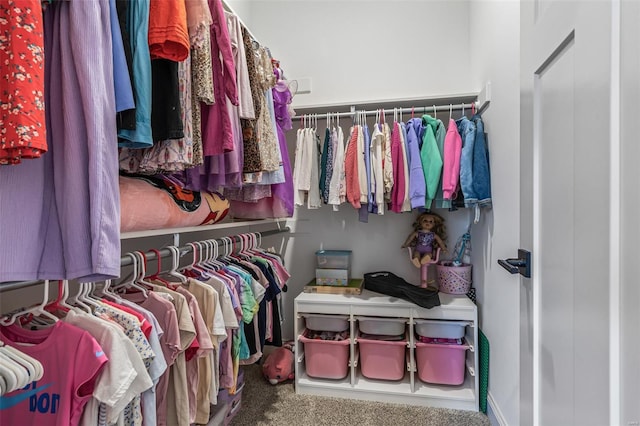 walk in closet with carpet floors