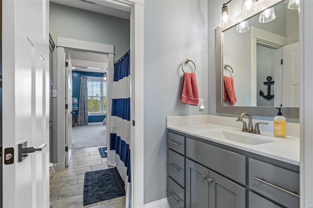 full bathroom featuring baseboards and vanity