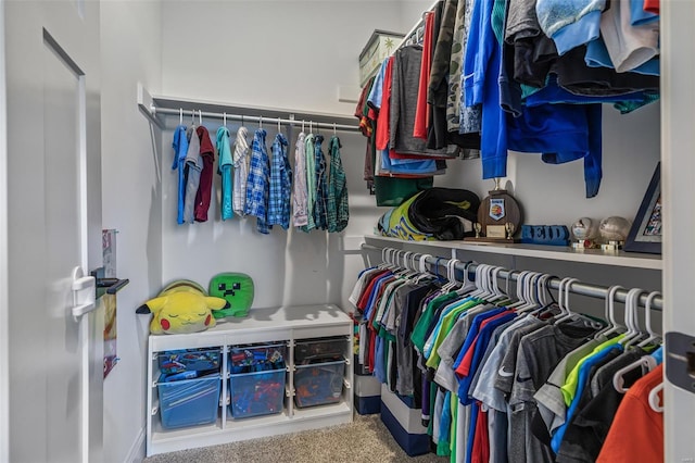 walk in closet with carpet