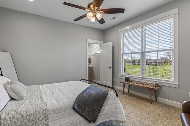 bedroom with baseboards, a ceiling fan, visible vents, and light carpet