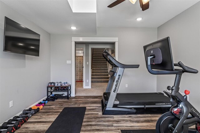 exercise room featuring baseboards, a ceiling fan, wood finished floors, and recessed lighting