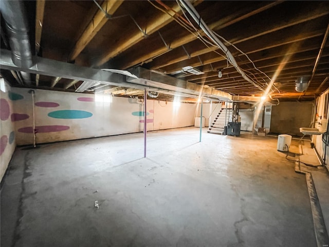 unfinished basement featuring stairs