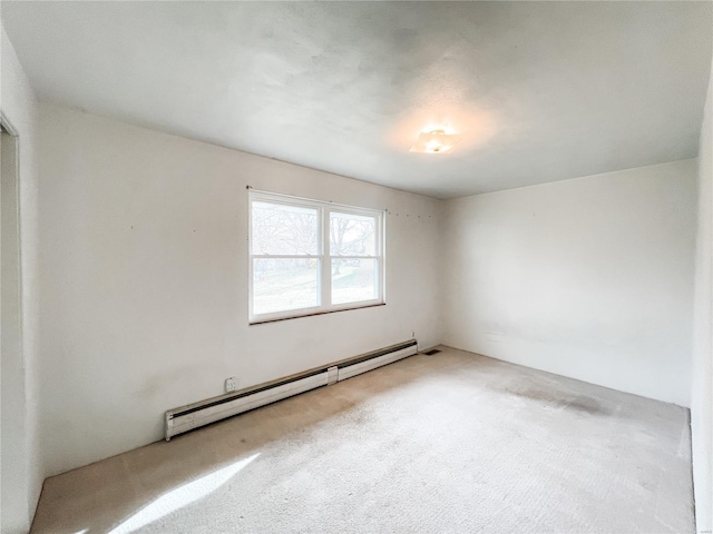spare room with carpet flooring and a baseboard radiator
