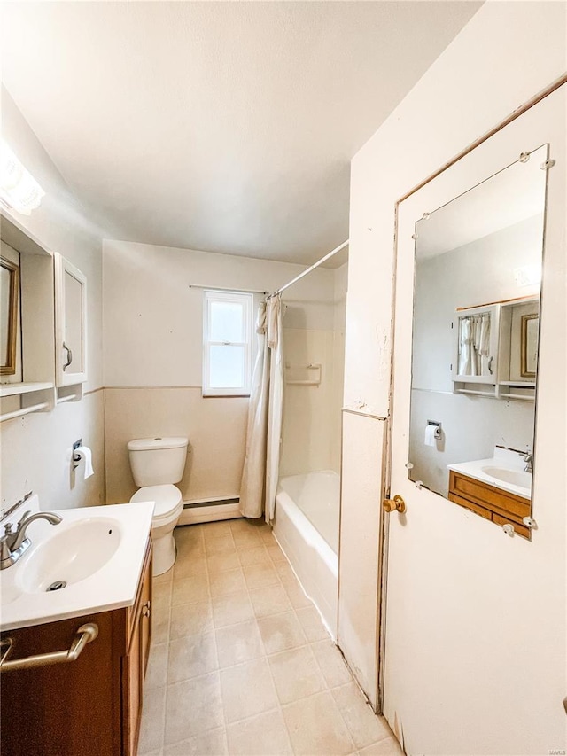 bathroom with tile patterned flooring, toilet, vanity, a baseboard radiator, and shower / tub combo