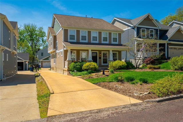 view of front facade with a porch and a detached garage