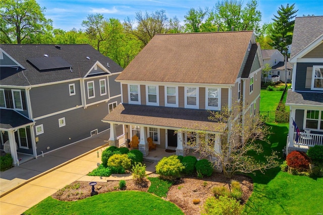 view of front of home with covered porch and a shingled roof