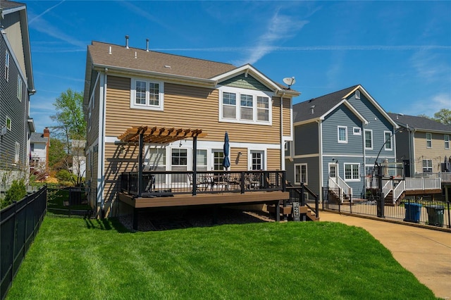 rear view of property featuring a residential view, a pergola, a wooden deck, a fenced backyard, and a lawn