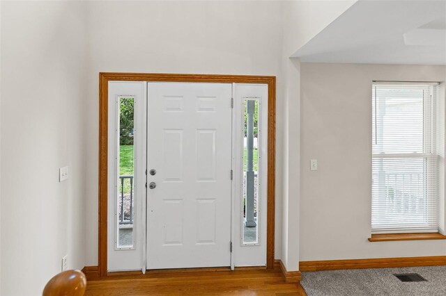 entrance foyer with visible vents, baseboards, and wood finished floors
