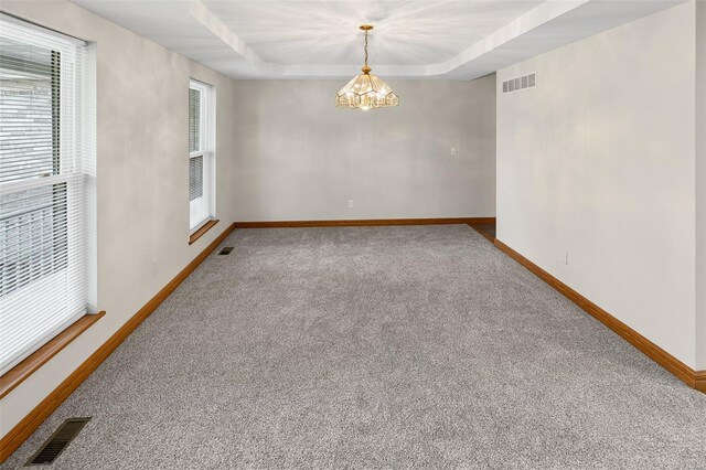 spare room with baseboards, visible vents, and carpet floors