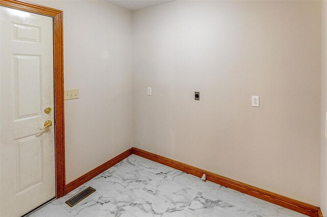 laundry area with hookup for an electric dryer, baseboards, visible vents, marble finish floor, and laundry area
